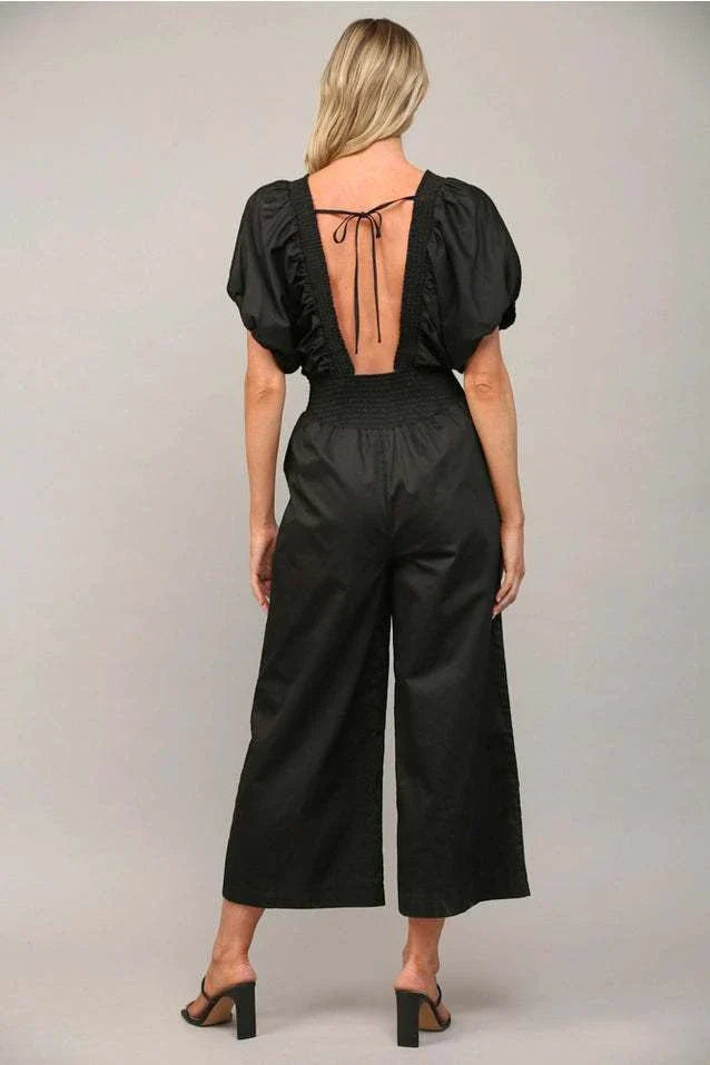 Fashionable open tie back jumpsuit with open back and adjustable tie.